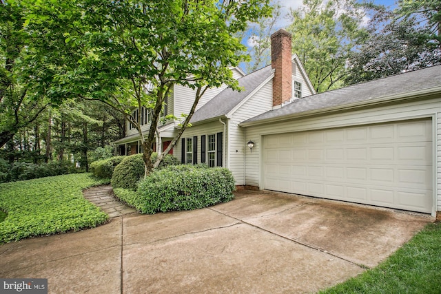 1881 Cold Creek Ct, Vienna, VA 22182 - view of front of home with a garage, driveway, a chimney, and roof with shingles