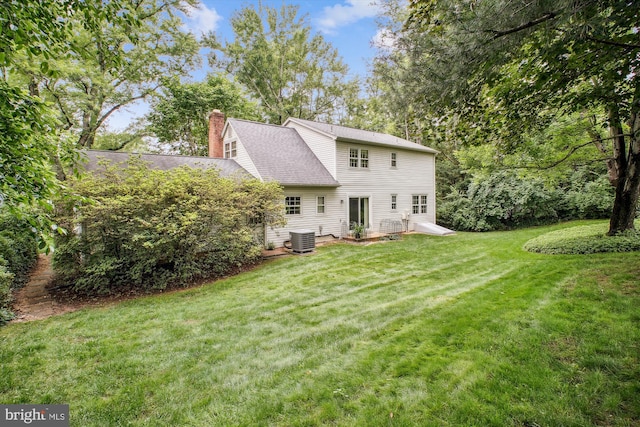 1881 Cold Creek Ct, Vienna, VA 22182 - rear view of house with a yard, a chimney, cooling unit, and roof with shingles