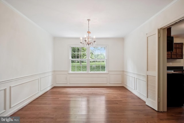 1881 Cold Creek Ct, Vienna, VA 22182 - unfurnished dining area featuring a chandelier, wood finished floors, wainscoting, crown molding, and a decorative wall