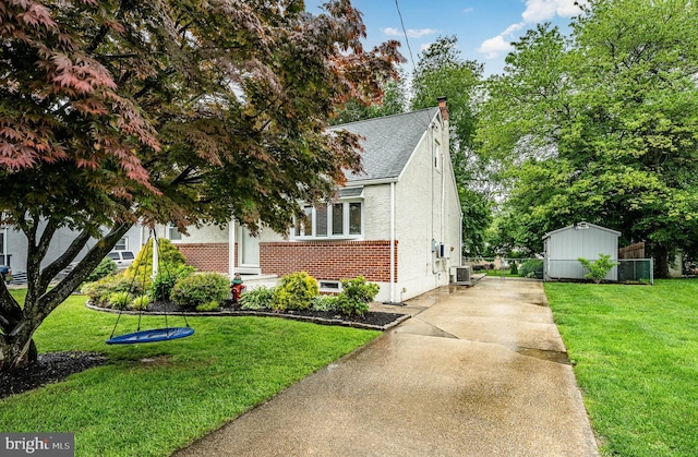618 Ruth, Upper Chichester, PA 19014 - view of front facade featuring driveway, central AC, a shingled roof, a chimney, and stucco siding