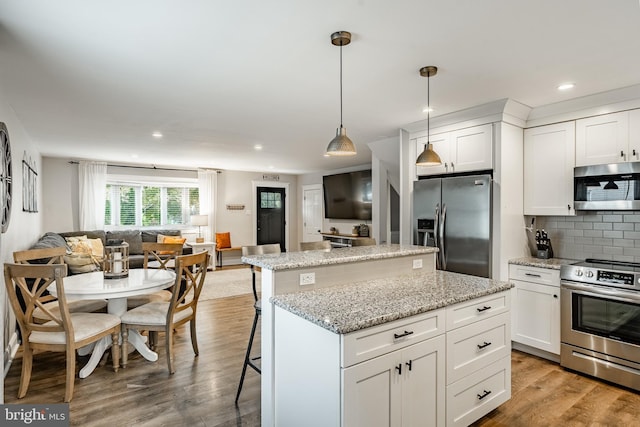 618 Ruth, Upper Chichester, PA 19014 - kitchen featuring appliances with stainless steel finishes, a center island, open floor plan, recessed lighting, and wood finished floors