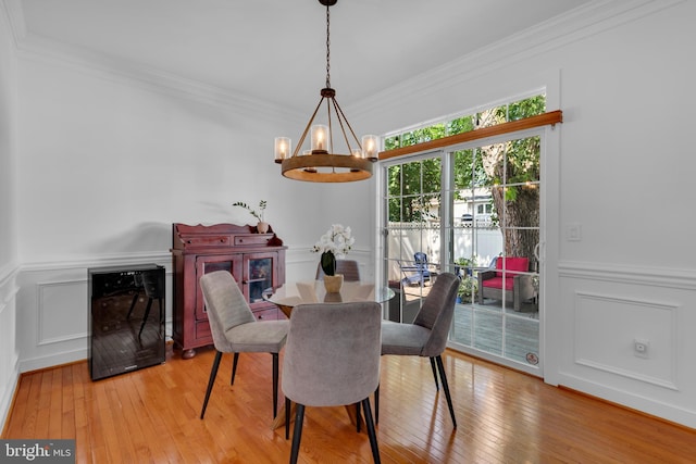 620 Cypress Ln, Severna Park, MD 21146 - dining area featuring a chandelier, hardwood / wood-style flooring, a decorative wall, ornamental molding, and wainscoting