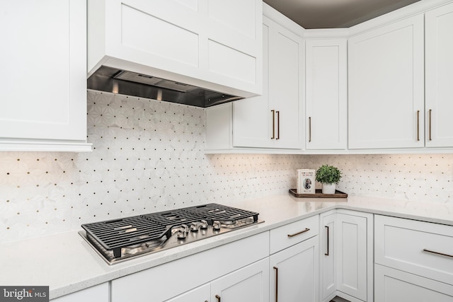 2638 Hollow View Dr, Easton, PA 18040 - kitchen featuring stainless steel gas cooktop, white cabinets, light countertops, tasteful backsplash, and premium range hood