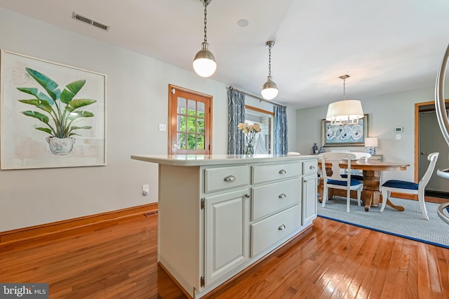 665 Bayard Rd, Lothian, MD 20711 - kitchen featuring light wood-style floors, hanging light fixtures, light countertops, and baseboards