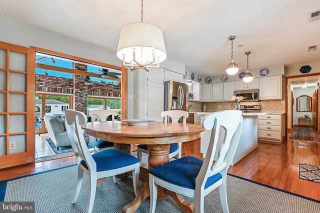 665 Bayard Rd, Lothian, MD 20711 - dining room with hardwood / wood-style floors, a ceiling fan, and a chandelier