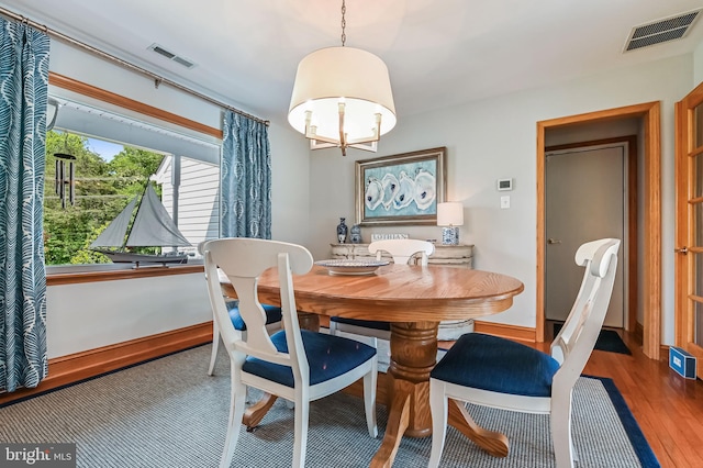 665 Bayard Rd, Lothian, MD 20711 - dining space with a chandelier, wood finished floors, and baseboards