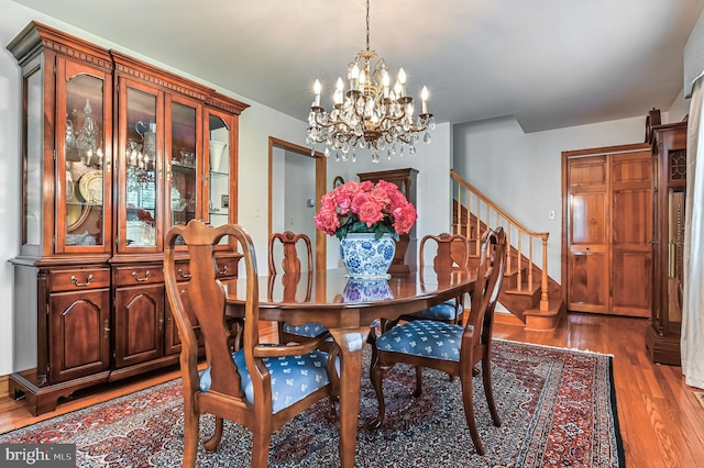 665 Bayard Rd, Lothian, MD 20711 - dining area with wood finished floors, stairway, and a chandelier