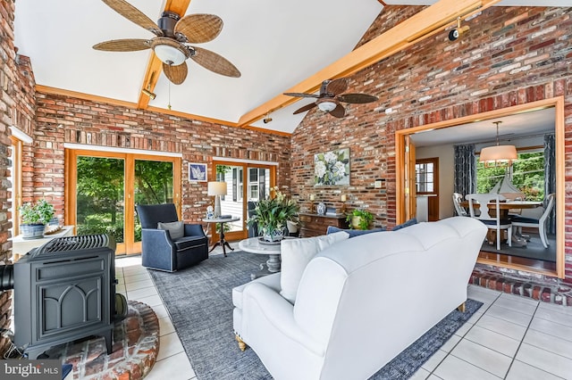 665 Bayard Rd, Lothian, MD 20711 - living room with brick wall, ceiling fan, tile patterned flooring, healthy amount of natural light, and high vaulted ceiling