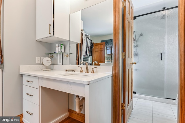 665 Bayard Rd, Lothian, MD 20711 - bathroom featuring a stall shower, vanity, tile patterned floors, and a walk in closet