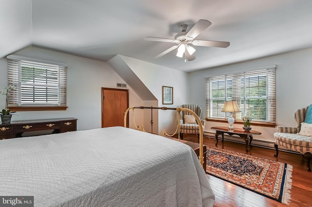 665 Bayard Rd, Lothian, MD 20711 - bedroom featuring hardwood / wood-style flooring, a baseboard radiator, vaulted ceiling, ceiling fan, and baseboards