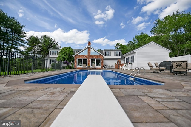 665 Bayard Rd, Lothian, MD 20711 - view of pool featuring an exterior structure, a patio area, an outdoor structure, and a diving board