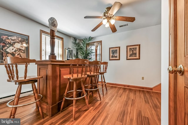 665 Bayard Rd, Lothian, MD 20711 - indoor dry bar featuring wood finished floors, a ceiling fan, and baseboards