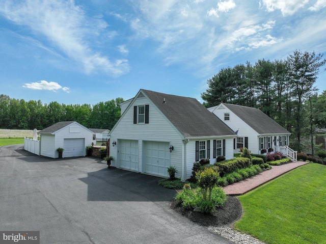 665 Bayard Rd, Lothian, MD 20711 - view of front facade with a front yard, an outbuilding, and roof with shingles