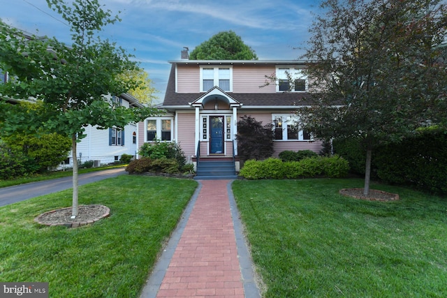 67 N American St, Woodbury, NJ 08096 - view of front of property featuring a front yard, a chimney, and roof with shingles