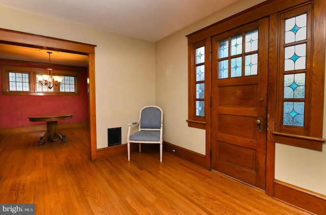 67 N American St, Woodbury, NJ 08096 - foyer entrance with wood finished floors, baseboards, and a chandelier
