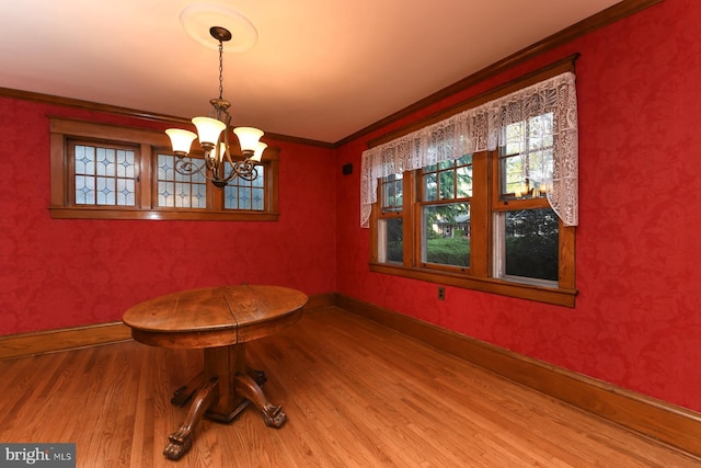 67 N American St, Woodbury, NJ 08096 - unfurnished dining area featuring wood finished floors, a chandelier, ornamental molding, and baseboards