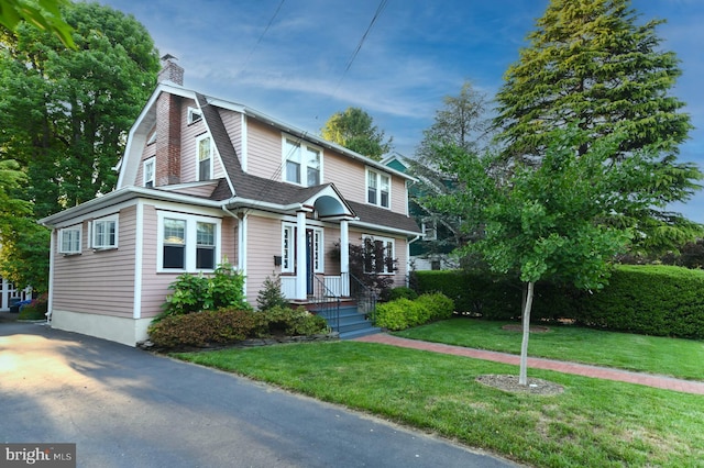 67 N American St, Woodbury, NJ 08096 - dutch colonial featuring a chimney, a front lawn, a shingled roof, and a gambrel roof