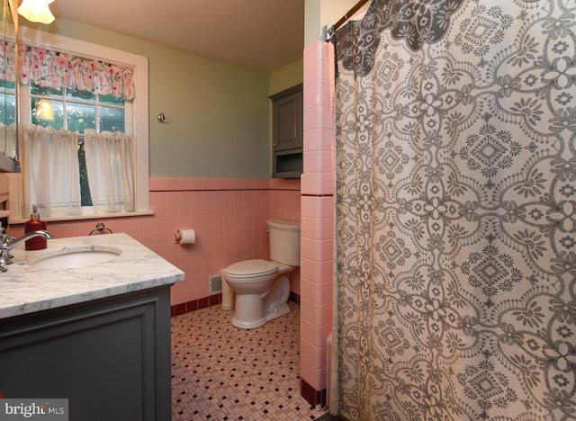 67 N American St, Woodbury, NJ 08096 - full bathroom with tile walls, toilet, a wainscoted wall, and vanity