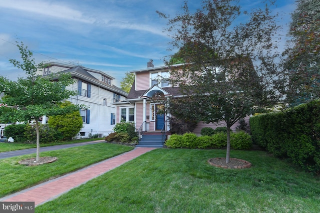 67 N American St, Woodbury, NJ 08096 - view of front of home with a front yard and a chimney