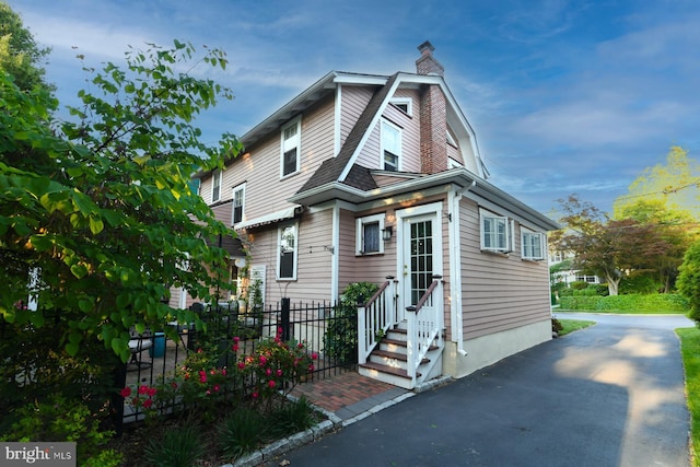 67 N American St, Woodbury, NJ 08096 - view of front of home featuring entry steps, a chimney, and a gambrel roof