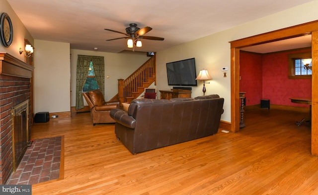 67 N American St, Woodbury, NJ 08096 - living area featuring a fireplace, a ceiling fan, light wood-style flooring, stairway, and baseboards