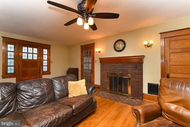 67 N American St, Woodbury, NJ 08096 - living room featuring wood finished floors, ceiling fan, and a brick fireplace