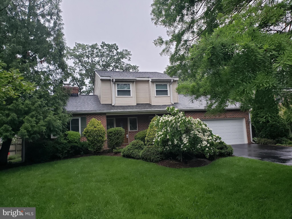 6188 Cobbs Rd, Alexandria, VA 22310 - traditional home with asphalt driveway, a front yard, brick siding, and a shingled roof