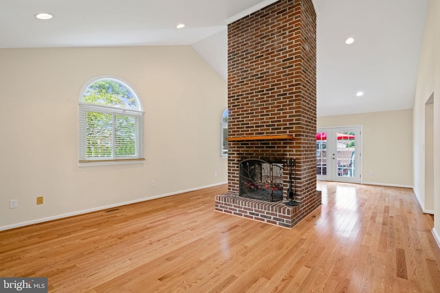 6188 Cobbs Rd, Alexandria, VA 22310 - unfurnished living room featuring healthy amount of natural light, lofted ceiling, wood finished floors, a brick fireplace, and recessed lighting