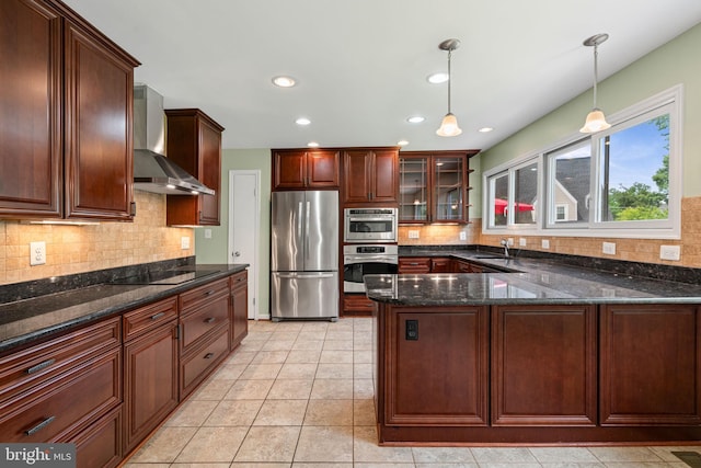 6188 Cobbs Rd, Alexandria, VA 22310 - kitchen with appliances with stainless steel finishes, wall chimney exhaust hood, a peninsula, hanging light fixtures, and backsplash