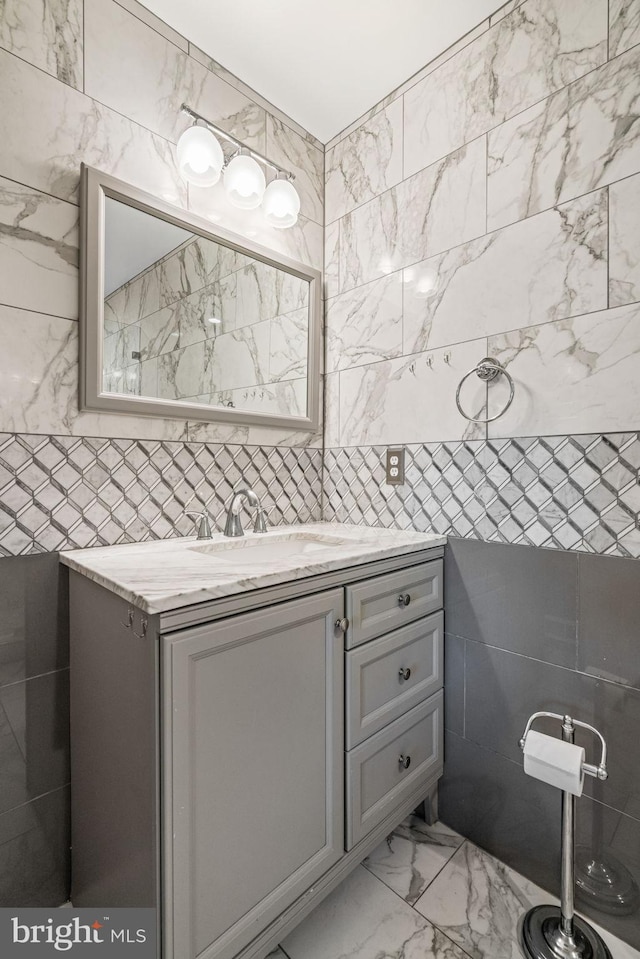 6188 Cobbs Rd, Alexandria, VA 22310 - bathroom featuring tile walls, vanity, and marble finish floors