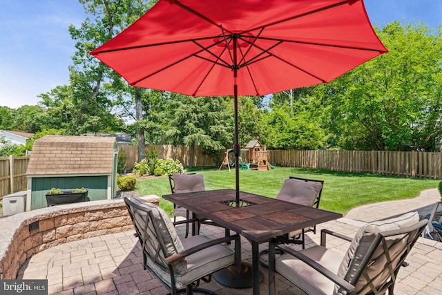 6188 Cobbs Rd, Alexandria, VA 22310 - fenced backyard with outdoor dining area, a patio area, a playground, and a shed