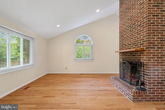 6188 Cobbs Rd, Alexandria, VA 22310 - unfurnished living room with light wood-type flooring, a brick fireplace, vaulted ceiling, and recessed lighting