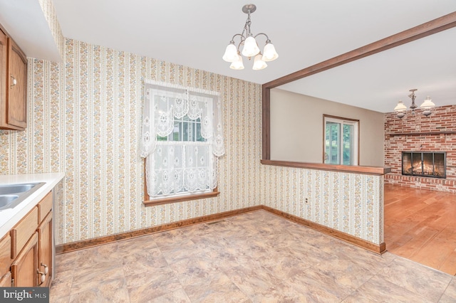 56 Pine Dr, Kirkwood, PA 17536 - kitchen featuring a chandelier, baseboards, pendant lighting, light countertops, and a fireplace