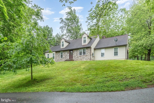 56 Pine Dr, Kirkwood, PA 17536 - cape cod-style house featuring stone siding, a front lawn, and a chimney