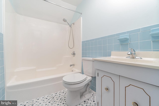 56 Pine Dr, Kirkwood, PA 17536 - bathroom featuring tile walls, vanity, toilet, shower / bathtub combination, and a wainscoted wall