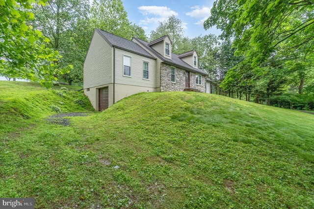 56 Pine Dr, Kirkwood, PA 17536 - view of home's exterior with an attached garage, a lawn, and stone siding