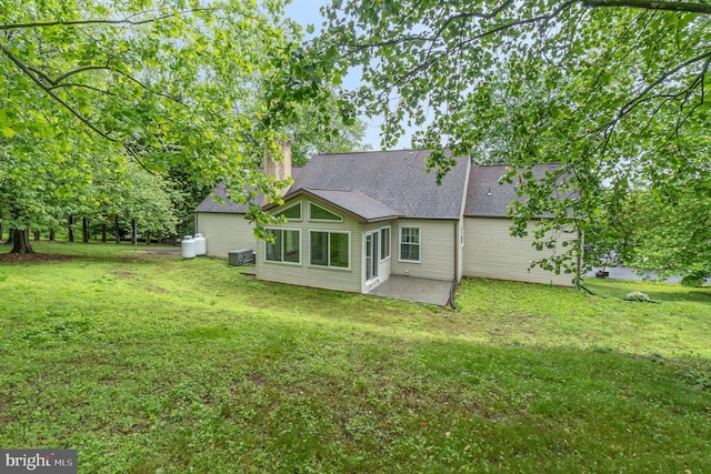 56 Pine Dr, Kirkwood, PA 17536 - rear view of property with a patio area, a lawn, a chimney, and cooling unit
