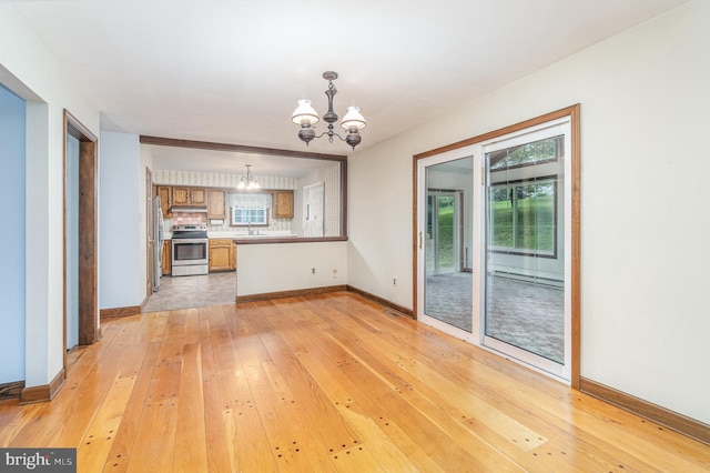 56 Pine Dr, Kirkwood, PA 17536 - unfurnished living room featuring a chandelier, light wood-style floors, baseboards, and a sink