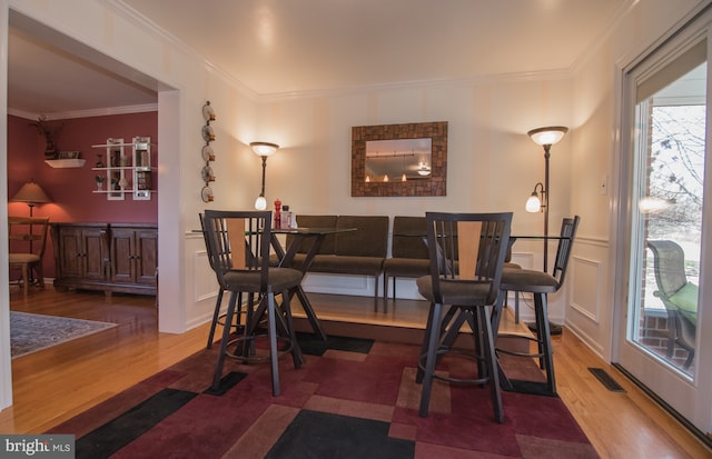 65 White Bark Dr, Middletown, DE 19709 - dining area with wood finished floors, ornamental molding, wainscoting, and a decorative wall