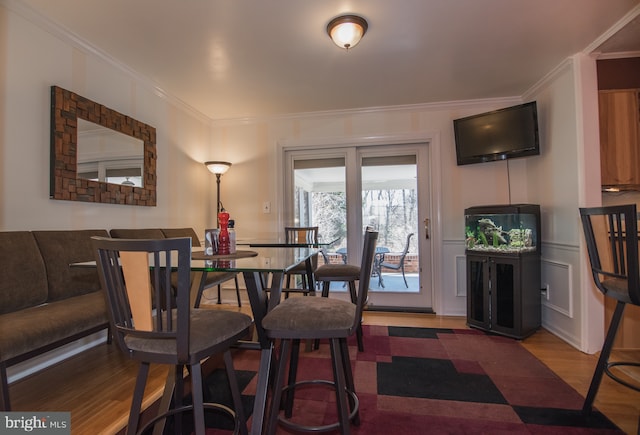 65 White Bark Dr, Middletown, DE 19709 - dining area featuring ornamental molding, wood finished floors, and a decorative wall