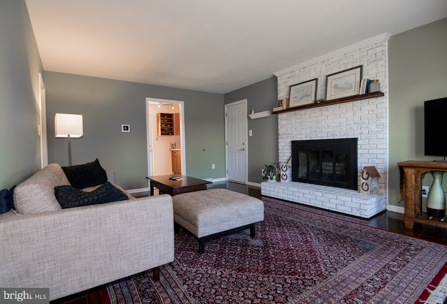 65 White Bark Dr, Middletown, DE 19709 - living room featuring a fireplace, baseboards, and wood finished floors