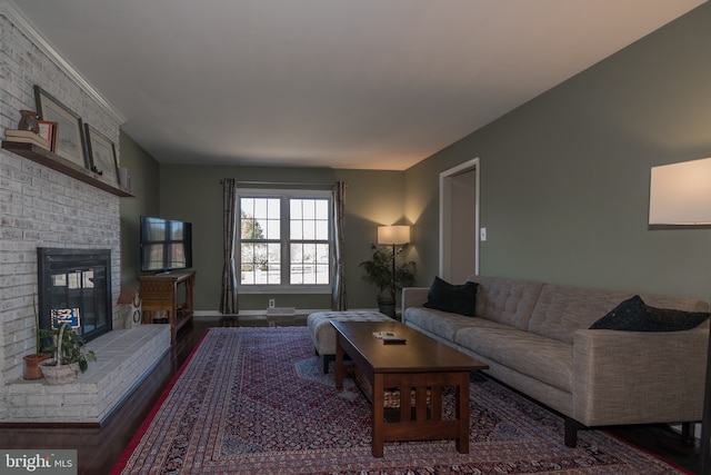 65 White Bark Dr, Middletown, DE 19709 - living area with wood finished floors, a brick fireplace, and baseboards