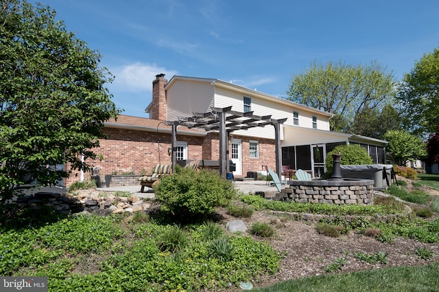 65 White Bark Dr, Middletown, DE 19709 - back of property featuring a patio area, a pergola, brick siding, a chimney, and a sunroom
