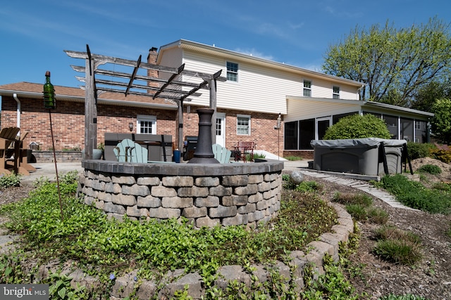 65 White Bark Dr, Middletown, DE 19709 - rear view of property featuring a sunroom, brick siding, a pergola, a patio, and a chimney