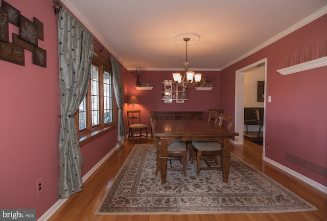 65 White Bark Dr, Middletown, DE 19709 - dining area featuring wood finished floors, crown molding, a chandelier, and baseboards