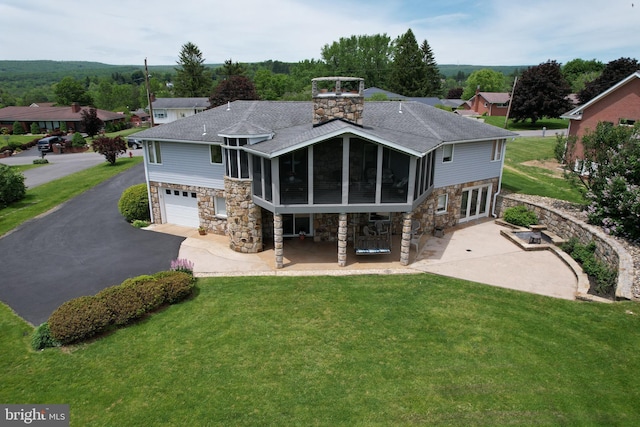 108 Wright St SE, Frostburg, MD 21532 - back of house with stone siding, asphalt driveway, a sunroom, and roof with shingles