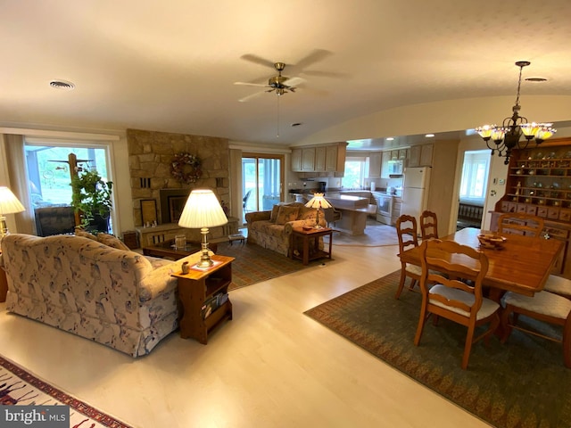 108 Wright St SE, Frostburg, MD 21532 - living area with wood finished floors, ceiling fan, a chandelier, lofted ceiling, and a fireplace