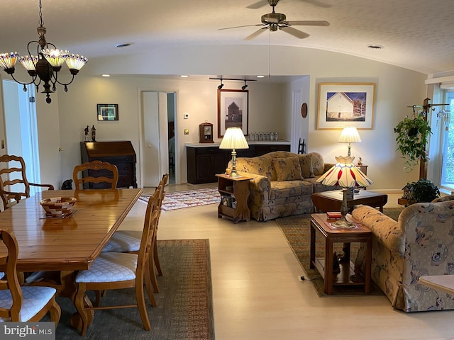 108 Wright St SE, Frostburg, MD 21532 - dining room with light wood finished floors, a ceiling fan, a chandelier, and vaulted ceiling