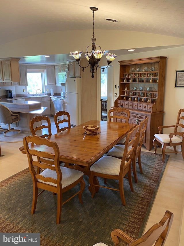 108 Wright St SE, Frostburg, MD 21532 - dining area featuring vaulted ceiling, a chandelier, and wood finished floors