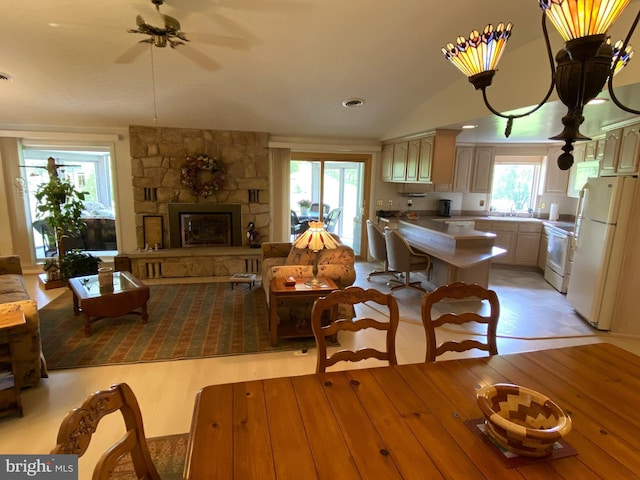 108 Wright St SE, Frostburg, MD 21532 - dining area featuring a stone fireplace, vaulted ceiling, light wood finished floors, a ceiling fan, and recessed lighting